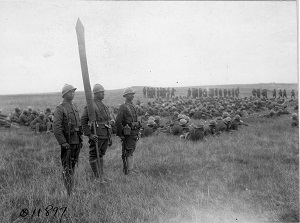 Flag bearers with troops in background